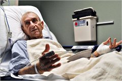 Old men in a hospital bed